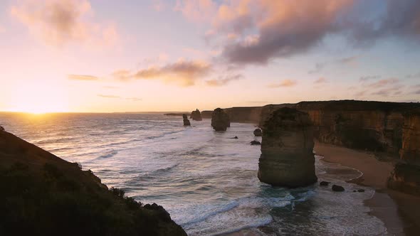 sun sets on the famous twelve apostles rock formations on the great ocean road alt