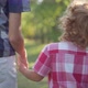 Redhead Curlyhaired Little Boy Holding Brother Hand Walking in Sunbeam in Spring Summer Park - VideoHive Item for Sale