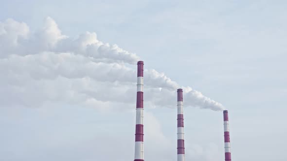 White Smoke From the Chimneys of a Thermal Power Plant Against a Blue Sky alt