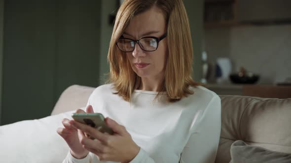 Woman Using Smartphone at Living Room alt