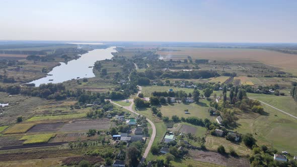 Aerial View of Ukrainian Small Village Against the Backdrop Green Fields and Sky alt