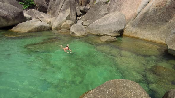 Woman Enjoys Her Vacation on Tropical Island, She Swims at Clear Ocean Water alt