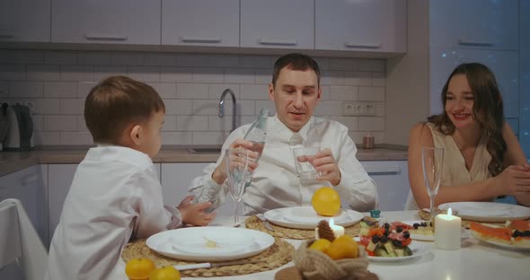 Large Caucasian Family Celebrating Thanksgiving Day Chatting at Dinner Party Table While Eating alt