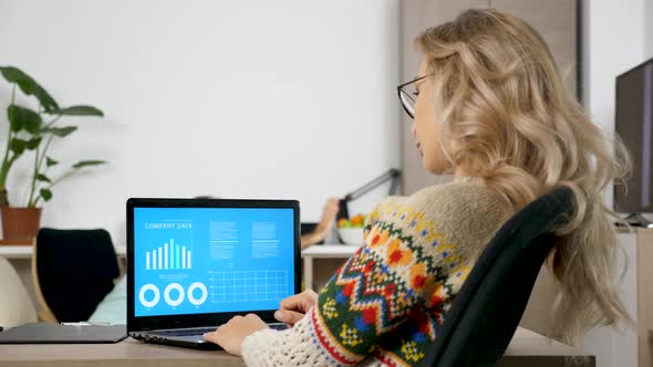 Woman Studying Company Data Analysis on Animated Chart While Her Husband Is Making a Lot of Noise in alt