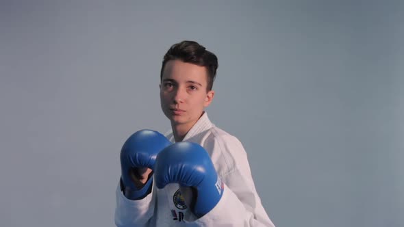 Woman Training Taekwondo Tricks in Gym alt