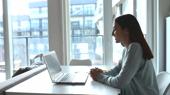 Happy Young Woman Using Laptop Computer for Video Connection From Home alt