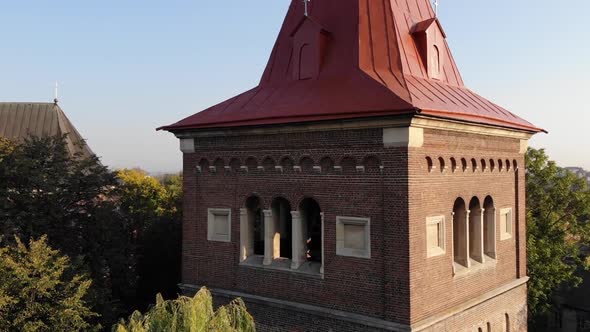 Aerial flyover near medieval Bell Tower. Crane shot with zoom in. Landscape of Drohobych town alt