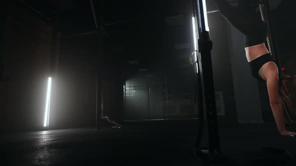 Sporty Woman is Doing Yoga Exercise Handwalk for Training Her Body and Keeping Balance alt