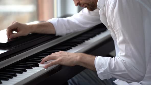The composer-pianist improvises, composes music and plays the piano. alt
