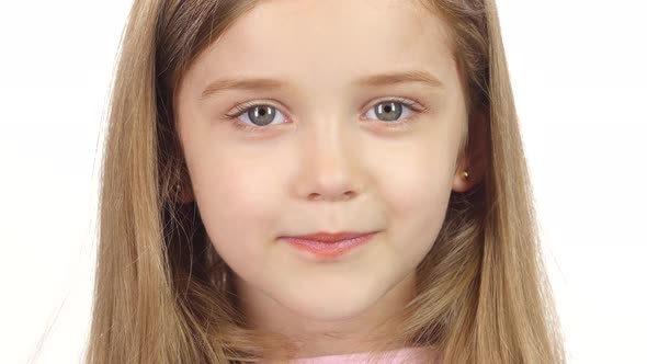 Child Genuinely Smile at the Camera. White Background. Close Up alt