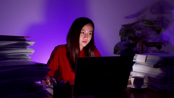 Woman working at home at night