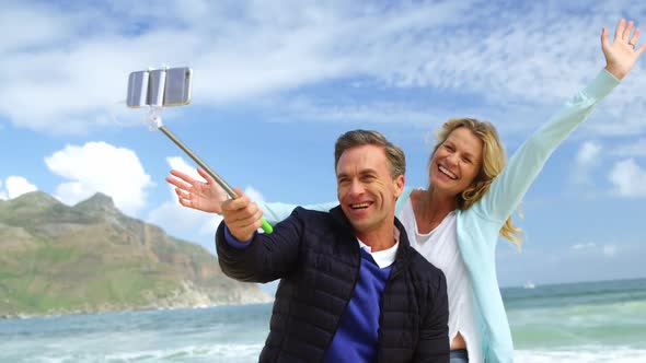 Mature couple taking a selfie from selfie stick alt