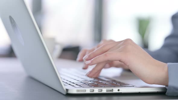 Close Up of Hands of Female Typing on Laptop Keyboard alt