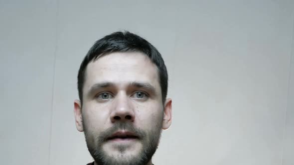 A Young Attractive Guy Opens a Box and Puts Sweets There While Preparing a Gift alt