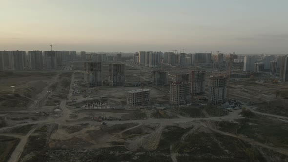 Construction site of a modern city block. High-rise buildings under construction. alt