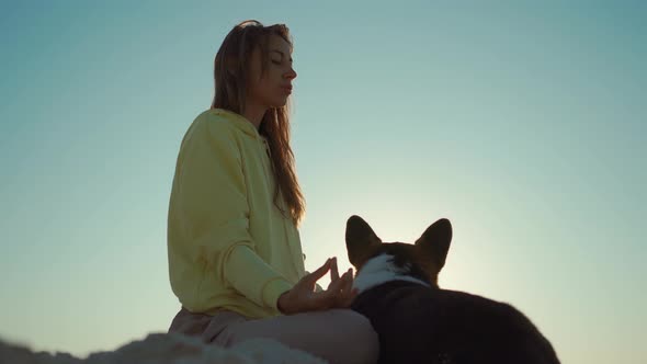 Pretty Confident Woman Doing Yoga and Meditation Practicing at Sunrise on Beach alt