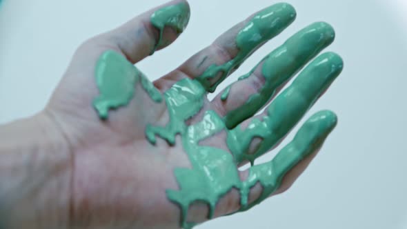 Closeup Hand in Soiled Acrylic Paint in Tidewater Green alt