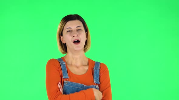 Girl Listens Carefully To Boring Information and Looks Around. Green Screen alt