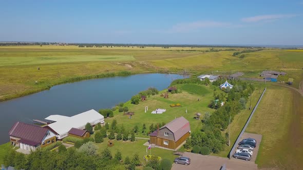 Wedding Venue with Arch and Seats on Green Meadow Upper View alt