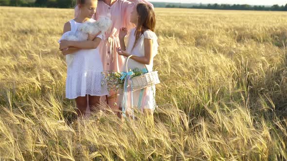 Happy Family Playing in a Wheat Field