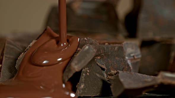 Super Slow Motion Shot of Pouring Melted Chocolate on Raw Chocolate Chunks at 1000 Fps alt