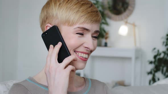 Headshot Portrait Beautiful Lady Sit in Modern Living Room Talk on Mobile Phone Receive Consultation alt