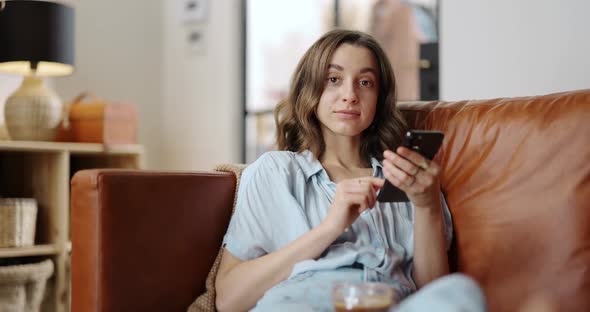 Woman with a Smart Phone at Cozy Home alt