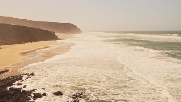 Aerial Drone View of Praia Grande Sandy Beach with Cliffs, showing Coastal Scenery and Coastline at alt