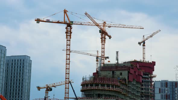 Tower Cranes Working Moving Heavy Loads at City alt