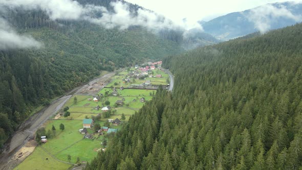 Village in the Carpathian Mountains in Autumn. Slow Motion, Aerial View alt
