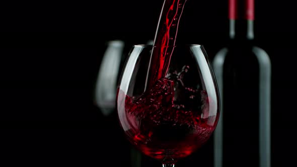 Super Slow Motion Shot of Pouring Red Wine on Black Background at 1000Fps alt