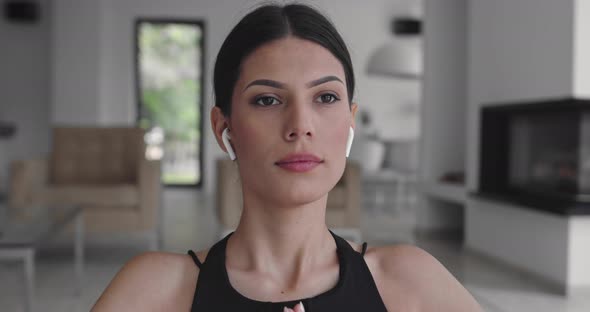 Beautiful Girl Using Smartphone After Fitness Workout at Home alt