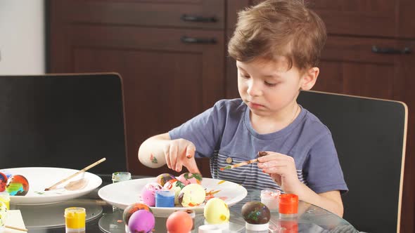 Easter Celebration Concept. Happy Little Boy Decorating Easter Eggs for Holiday.