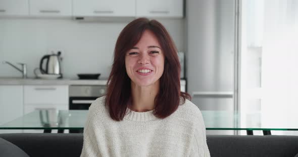 Screen Webcam View of Joyful Young Woman in Earphones Talk Before Camera with Smile Meet Friend alt