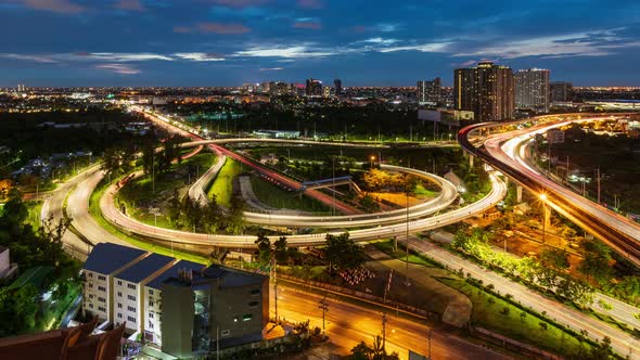 Highway interchange junction and traffic during rush hour at Bangkok, day to night - time lapse