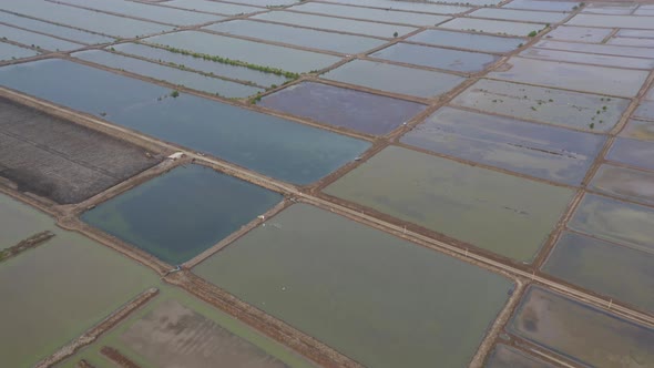 Aerial top view of natural sea salt ponds. Farm field outdoor. Material in traditional industry alt