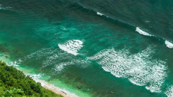 Aerial View of Waves Rolling One By One To the Nunggalan Beach Near Uluwatu, Bali, Indonesia alt