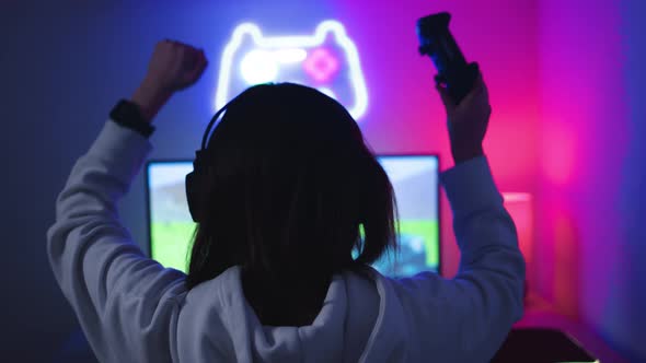 Young Gamer Playing Strategy Video Game Celebrating Victory  Technology Esport Concept alt