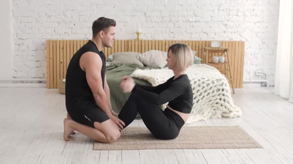 Young Couple Man and Woman Training Together in Bedroom at Home on Quarantine