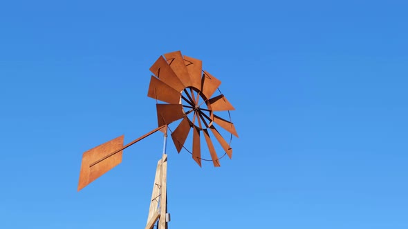 Windmill with Brown Blades Used to Extract Water in the Dry Terrain of African Countries alt