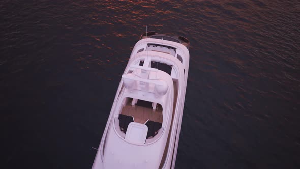 Big, luxury yacht sailing in the lake during beautiful pink sunset. 4K HD