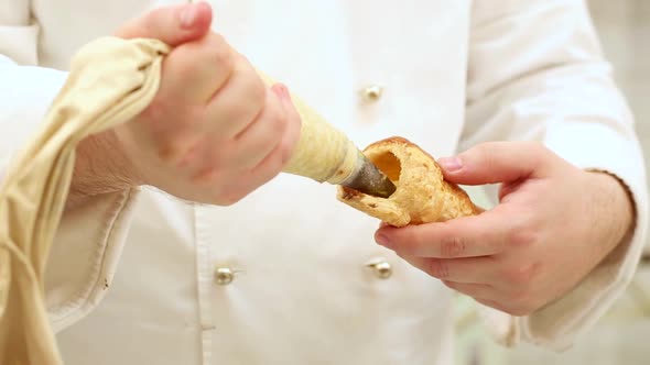 Pastry chef at work in a restaurant kitchen or cake shop preparing sweet delicious food