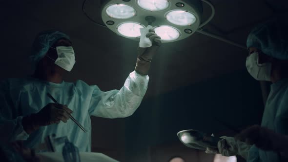 Doctor Adjusting Surgery Lights in Operating Room alt