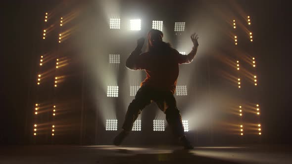 Professional Young Hip-hop Dancer, Dancing in Dark Studio in the Green and Yellow Fog. Hip Hop alt