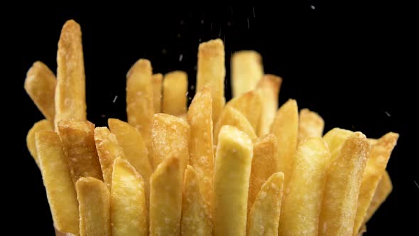 Adding Salt On Crispy French Fries In Slow Motion 