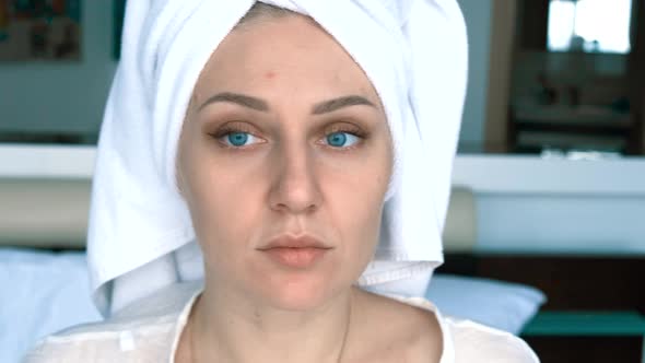Portrait of a Young Woman with a Towel on Her Head After a Shower alt
