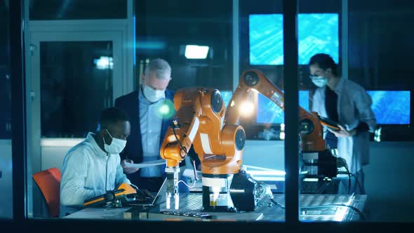 Group Researchers Face Masks Are Examining Robotic Devices alt