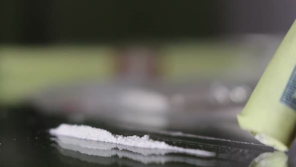 Man Sniffing Cocaine Through A Hundred Dollar Bill