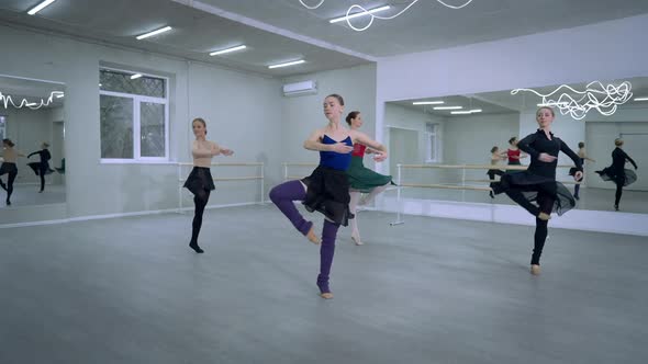 Group of Talented Ballerinas Rehearsing Simultaneous Ballroom Turn alt
