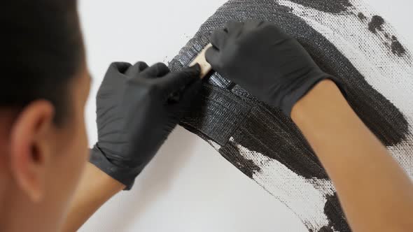 Artist in Black Gloves Draws Picture of Grey Colour Closeup alt